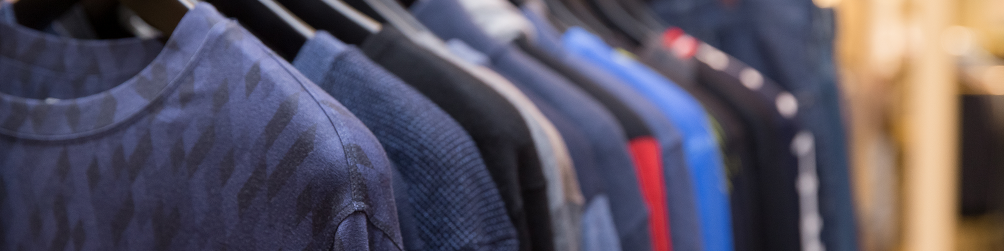Various Blue Shirts on a Rack
